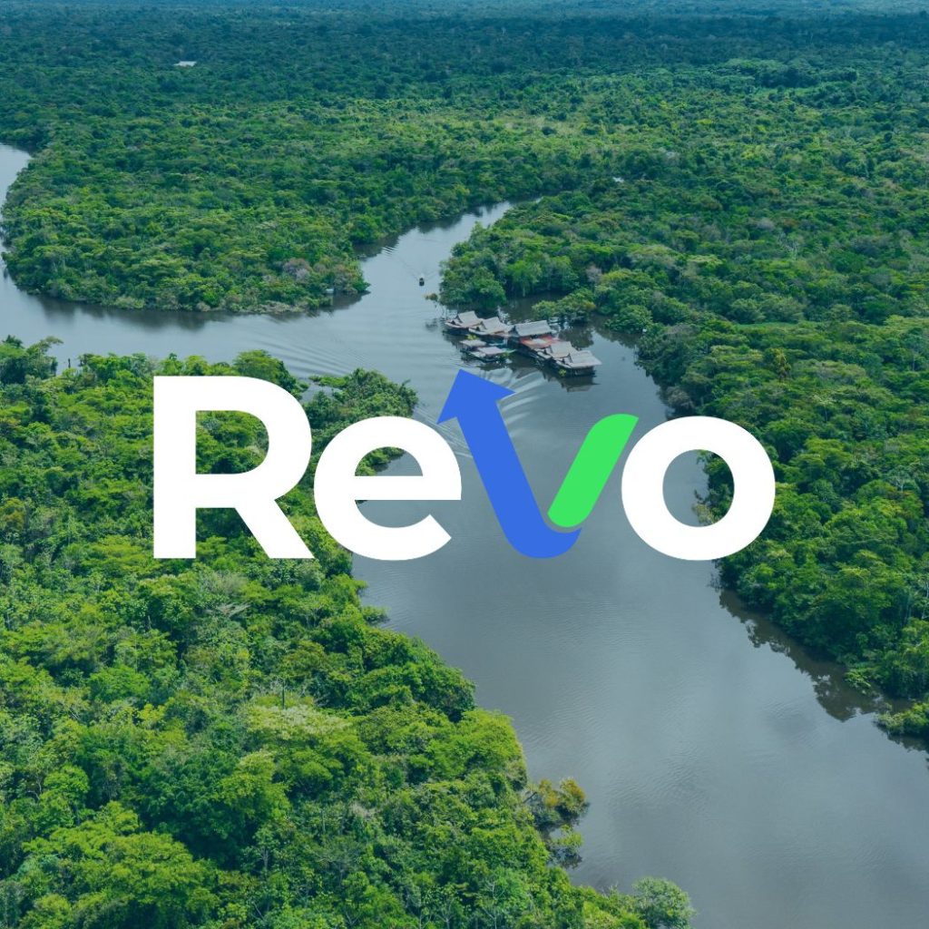 Aerial view of a lush green rainforest with a river winding through it, overlaid with the text 'Revo' in white and blue with an upward pointing arrow forming the letter 'v'.